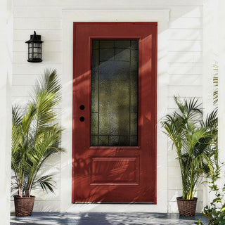 Red entry door with large frosted glass panel and paneling between potted palms.