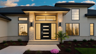 Framewell modern house entrance with black door and stone pillars.