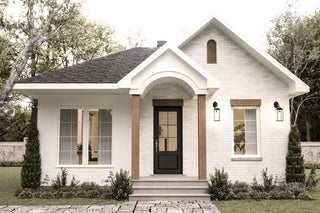 White brick modern farmhouse with a dark entry door and wooden porch posts.