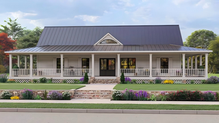 Large farmhouse exterior with black entry door, wraparound porch, and landscaped front yard